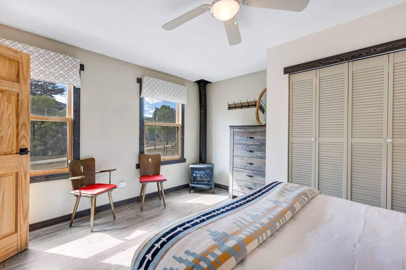 Bedroom with queen bed and wood stove