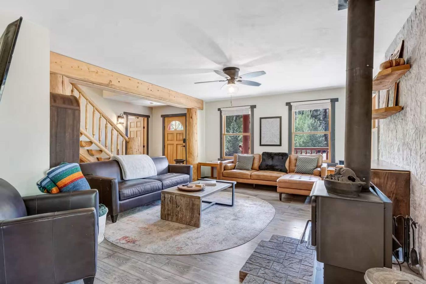 Open living room with sectional and wood stove