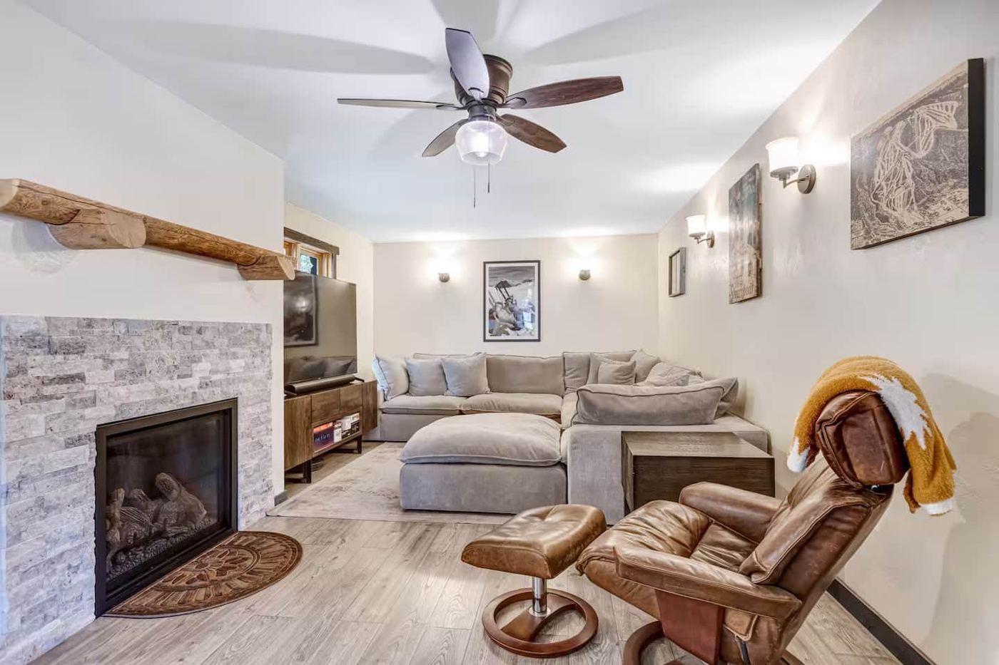 TV room with sectional and stone fireplace